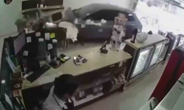 Video: Car crashes into candy store and nearly hits woman with child