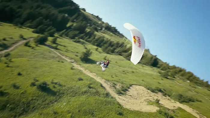 Radical video: Tom Pages jumps off a cliff with a motorbike and parachute in an incredible stunt (YouTube / @TomPagesOfficial)